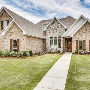 A large brick home with grass in front | New Park